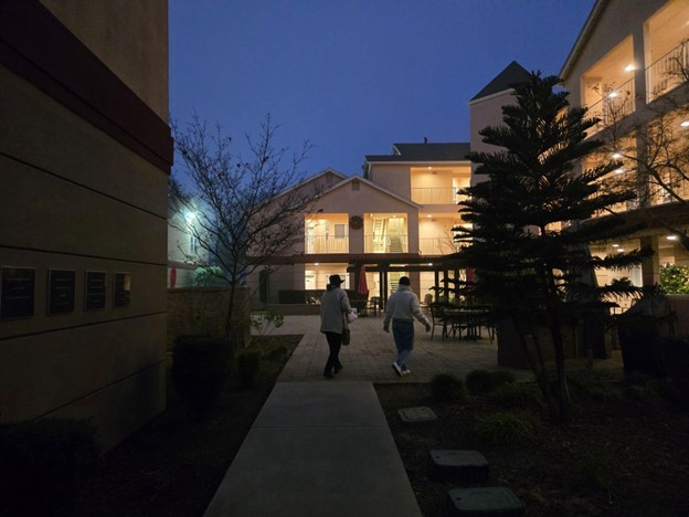 Seniors walking together outdoors during National Walking Month in a senior living community
